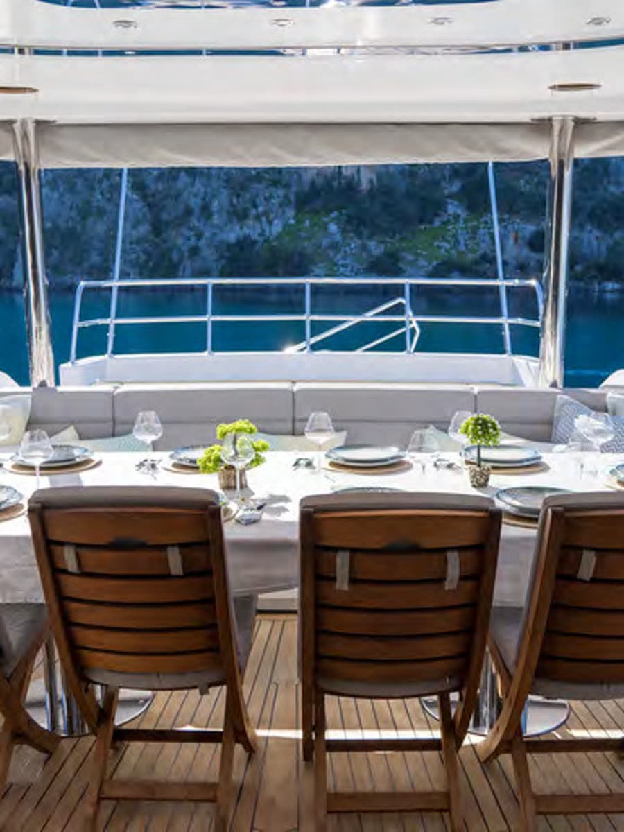The flybridge table set high over the water